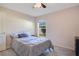 Comfortable bedroom offers natural light from the window and neutral decor at 107 Amber Blvd, Auburndale, FL 33823