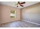 This bedroom features wood-look flooring, a ceiling fan, and neutral colors at 107 Amber Blvd, Auburndale, FL 33823