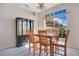 Bright dining room featuring wood table set, gray plank flooring, and natural light from a large window at 107 Amber Blvd, Auburndale, FL 33823