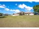 Charming single-story home featuring a two-car garage, well-manicured lawn, and delightful landscaping at 107 Amber Blvd, Auburndale, FL 33823