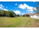 Charming single-story home featuring a two-car garage, well-manicured lawn, and delightful landscaping at 107 Amber Blvd, Auburndale, FL 33823