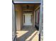 Inviting front porch with a white door framed by sidelights and a transom window, creating an elegant entrance at 107 Amber Blvd, Auburndale, FL 33823