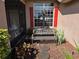 Inviting front porch with a welcome bench, red shutters, and decorative landscaping at 107 Amber Blvd, Auburndale, FL 33823