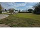 Lawn view of the home featuring a green lawn and some views of the lake in the distance at 107 Amber Blvd, Auburndale, FL 33823