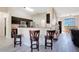 Open kitchen view with stainless steel appliances, dark cabinetry, breakfast bar and stool seating at 107 Amber Blvd, Auburndale, FL 33823