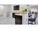 Cozy kitchen bar area with dark wood cabinets, a breakfast bar, and views into the open-concept living space at 107 Amber Blvd, Auburndale, FL 33823