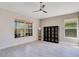 Open living area featuring neutral walls, modern ceiling fan, shelving unit, and plank flooring at 107 Amber Blvd, Auburndale, FL 33823