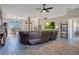 Spacious living room featuring tile floors, a ceiling fan, and ample natural light at 107 Amber Blvd, Auburndale, FL 33823