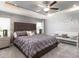 Serene main bedroom featuring tray ceilings, plush carpeting, and plenty of natural light at 1123 Aruba Ave, Mulberry, FL 33860