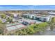 Aerial view of condominium buildings with community pool, tennis courts and surrounding landscape at 1130 N Lake Parker Ave # C328, Lakeland, FL 33805