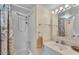 Well-lit bathroom with a shower-tub combination, clean white tiles and a vanity with a decorative mirror at 1130 N Lake Parker Ave # C328, Lakeland, FL 33805