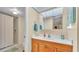 Clean bathroom with a walk-in shower and a wooden vanity at 1130 N Lake Parker Ave # C328, Lakeland, FL 33805