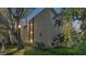 Exterior daytime view of the condo building with lush landscaping at 1130 N Lake Parker Ave # C328, Lakeland, FL 33805