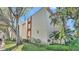 Well-maintained exterior of a multi-story residential building, surrounded by mature trees and landscaping at 1130 N Lake Parker Ave # C328, Lakeland, FL 33805