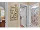 Hallway with decorative art leading to the bathroom and other rooms inside this home at 1130 N Lake Parker Ave # C328, Lakeland, FL 33805