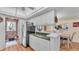 Bright kitchen featuring white cabinetry, a breakfast bar, and an open layout to the dining area at 1130 N Lake Parker Ave # C328, Lakeland, FL 33805