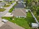 Aerial view of a single-story home with a large backyard, screened porch, and driveway with boat parking at 117 Belmont Dr, Winter Haven, FL 33884