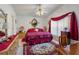 Bright bedroom featuring a patterned rug, bed with bedside tables and a ceiling fan at 117 Belmont Dr, Winter Haven, FL 33884