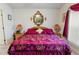 Bedroom featuring a large bed with decorative pillows and bedside tables with lamps at 117 Belmont Dr, Winter Haven, FL 33884