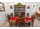 Elegant dining room with a large wooden table, seating for six, and a display cabinet at 117 Belmont Dr, Winter Haven, FL 33884