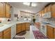 Well-lit kitchen with wooden cabinetry, white countertops, and modern appliances including a microwave at 117 Belmont Dr, Winter Haven, FL 33884