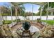 Screened-in lanai with outdoor seating and a view of the lush, well-maintained backyard at 117 Belmont Dr, Winter Haven, FL 33884