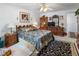 Comfortable main bedroom with classic furnishings, patterned bedding, and a mirrored dresser at 117 Belmont Dr, Winter Haven, FL 33884