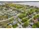 Aerial view of the home in a lakeside community with mature trees and well-maintained landscaping at 117 Belmont Dr, Winter Haven, FL 33884