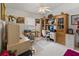 Home office featuring built-in shelving, a ceiling fan, and neutral-toned furnishings at 117 Belmont Dr, Winter Haven, FL 33884