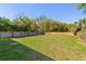 Expansive backyard with lush green grass and a wood fence, perfect for outdoor activities at 127 Florida Dr, Winter Haven, FL 33881