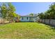 Backyard with lush green grass and a wood fence, perfect for outdoor activities at 127 Florida Dr, Winter Haven, FL 33881