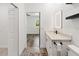 Bathroom featuring vanity with marble countertop, modern lighting and access to the bedroom at 127 Florida Dr, Winter Haven, FL 33881