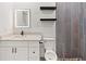 Bathroom featuring floating shelves and decorative shower tile, and vanity with marble countertop at 127 Florida Dr, Winter Haven, FL 33881