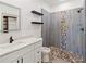 Modern bathroom featuring decorative tile accents, floating shelves, and a glass-enclosed shower at 127 Florida Dr, Winter Haven, FL 33881