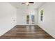 Bright bedroom with light wood-look flooring and french door access to the yard at 127 Florida Dr, Winter Haven, FL 33881