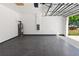 View of garage with epoxy flooring and garage door leading to the outdoors at 127 Florida Dr, Winter Haven, FL 33881