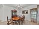 Formal dining room with elegant furniture, a chandelier, and large window for natural lighting at 1298 Zeek Ridge St, Clermont, FL 34715