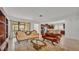 Bright living room with antique furniture that flows into the kitchen area at 1298 Zeek Ridge St, Clermont, FL 34715