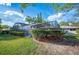 Lush backyard showcasing a screened-in pool, verdant lawn, and attractive landscaping at 1311 Glengreen Ln, Lakeland, FL 33813