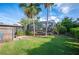 Well-manicured yard featuring a screened-in pool area with mature landscaping, perfect for outdoor relaxation at 1311 Glengreen Ln, Lakeland, FL 33813