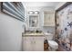 Charming bathroom featuring a vanity with stone countertop, and a seashell themed shower curtain at 1311 Glengreen Ln, Lakeland, FL 33813