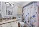 Comfortable bathroom featuring a vanity with stone countertop, and a seashell themed shower curtain at 1311 Glengreen Ln, Lakeland, FL 33813