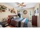 Cozy bedroom with wood-trimmed bed, ceiling fan, desk, and unique animal-themed decorations at 1311 Glengreen Ln, Lakeland, FL 33813