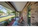 Charming covered front porch with rocking chairs, hanging plants, and a cozy welcome mat at 1311 Glengreen Ln, Lakeland, FL 33813