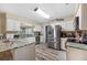 Well-lit kitchen featuring stainless steel appliances and granite countertops, offering both style and functionality at 1311 Glengreen Ln, Lakeland, FL 33813