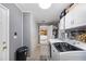 Efficient laundry room with washer, dryer, gray walls, and tiled floors at 1311 Glengreen Ln, Lakeland, FL 33813