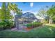 The screened-in pool area is surrounded by lush landscaping, creating a relaxing and private oasis at 1311 Glengreen Ln, Lakeland, FL 33813