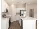 Beautiful kitchen featuring modern appliances, white cabinets, an island and wood-style flooring at 1327 Mottled Duck Ln, Lakeland, FL 33811