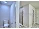 Bathroom featuring a walk-in shower with glass door and tile surround at 1588 Leamington Ln, Winter Haven, FL 33884