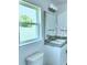 Bright bathroom featuring a modern vanity, stylish lighting, and a window for natural light at 1588 Leamington Ln, Winter Haven, FL 33884